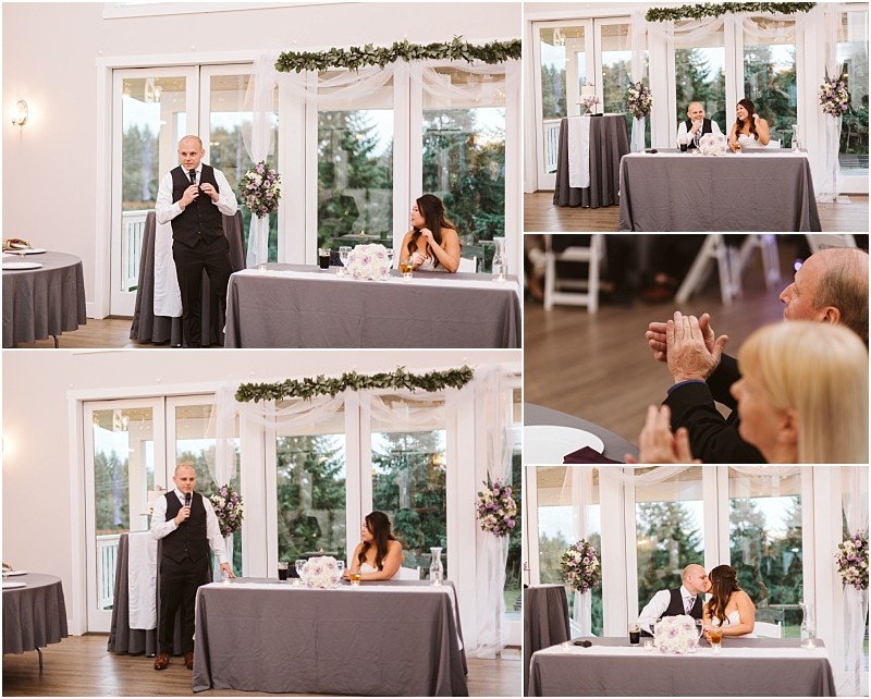 Premier Snohomish & Seattle Wedding Photographer | GSquared Weddings Photography A man gives a speech at a Snohomish wedding reception, standing beside a seated bride, while guests watch and applaud. The event takes place in a bright room with large windows and floral decorations. 47.9129° N, 122.0982° W | Serving Snohomish, Seattle , Orlando & Beyond