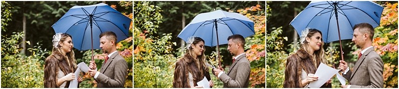 Premier Snohomish & Seattle Wedding Photographer | GSquared Weddings Photography A couple stands outdoors under a blue umbrella in Snohomish, exchanging vows and holding papers, surrounded by autumn foliage. The woman wears a fur stole and headpiece; the man is in a brown suit—a perfect Seattle wedding moment. 47.9129° N, 122.0982° W | Serving Snohomish, Seattle , Orlando & Beyond