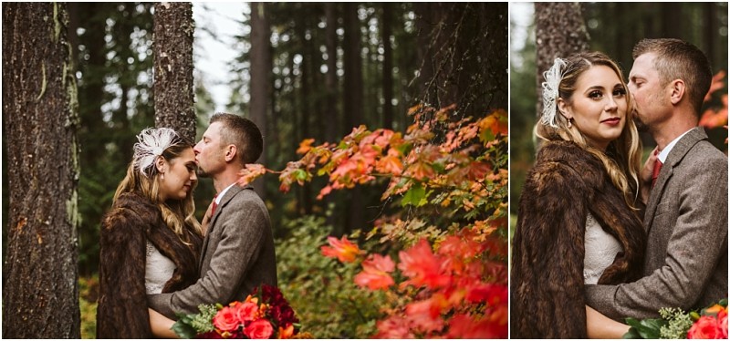 Premier Snohomish & Seattle Wedding Photographer | GSquared Weddings Photography A couple in wedding attire embraces in a forest with autumn foliage near Snohomish. The groom kisses the bride’s forehead as she holds a bouquet of red and orange flowers; both wear warm clothing for their Seattle wedding engagement. 47.9129° N, 122.0982° W | Serving Snohomish, Seattle , Orlando & Beyond