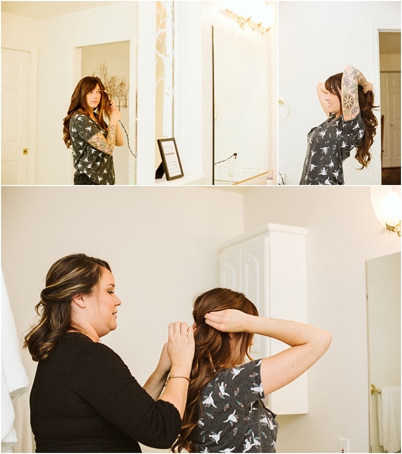 Premier Snohomish & Seattle Wedding Photographer | GSquared Weddings Photography A woman with long hair and tattoos styles her hair in front of a bathroom mirror, preparing for her Snohomish Seattle wedding. In another photo, a second woman helps fix her hair from behind in the well-lit, white-walled bathroom. 47.9129° N, 122.0982° W | Serving Snohomish, Seattle , Orlando & Beyond