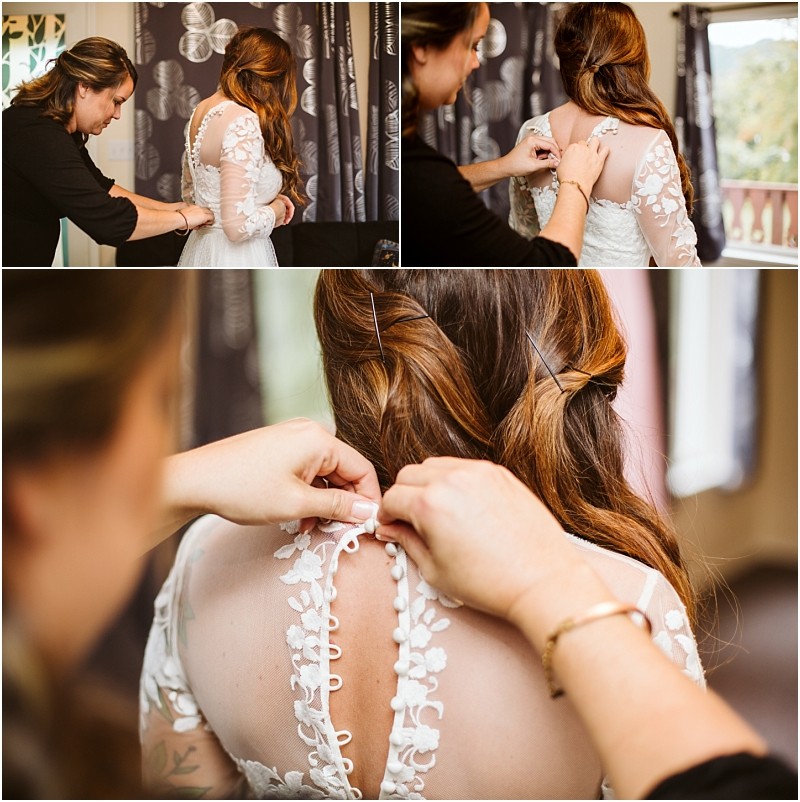 Premier Snohomish & Seattle Wedding Photographer | GSquared Weddings Photography A woman helps a bride in a white lace dress button up her gown. The photos focus on the bride’s back, highlighting intricate lace details and hands fastening buttons—capturing a beautiful Seattle wedding moment near a window with curtains. 47.9129° N, 122.0982° W | Serving Snohomish, Seattle , Orlando & Beyond