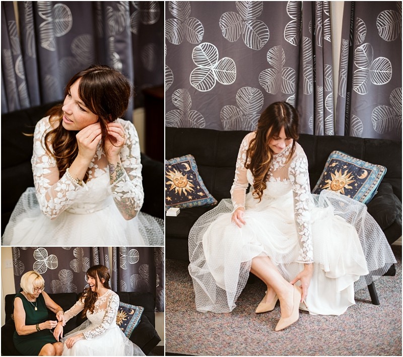 Premier Snohomish & Seattle Wedding Photographer | GSquared Weddings Photography A bride with long brown hair in a lace wedding dress sits on a sofa, putting on earrings and shoes before her Snohomish Seattle wedding. In another photo, an older woman helps her. Grey curtains and decorative pillows are in the background. 47.9129° N, 122.0982° W | Serving Snohomish, Seattle , Orlando & Beyond