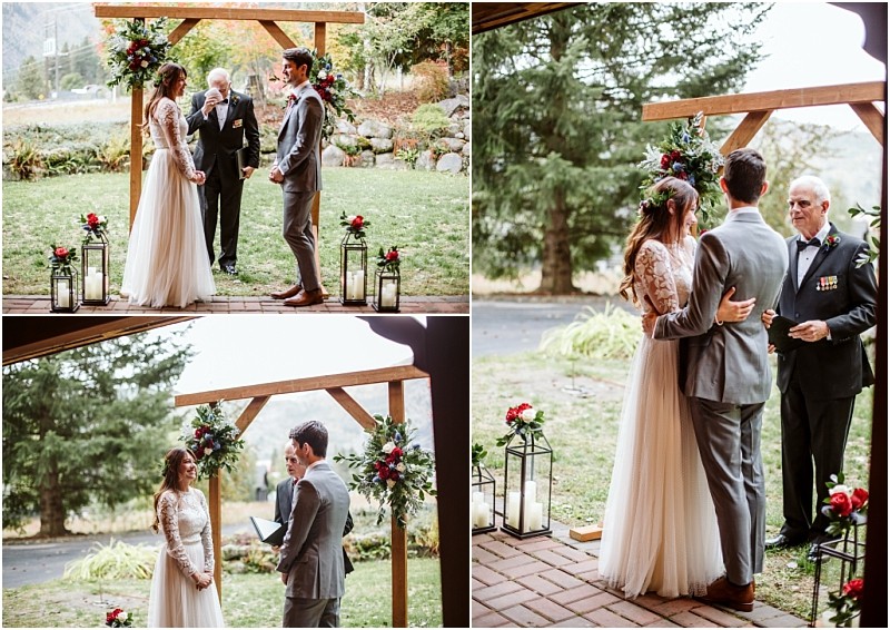 Premier Snohomish & Seattle Wedding Photographer | GSquared Weddings Photography A bride and groom stand together under a wooden arch decorated with flowers during their outdoor Snohomish wedding ceremony. A man officiates as they exchange vows, surrounded by greenery and candle lanterns. 47.9129° N, 122.0982° W | Serving Snohomish, Seattle , Orlando & Beyond