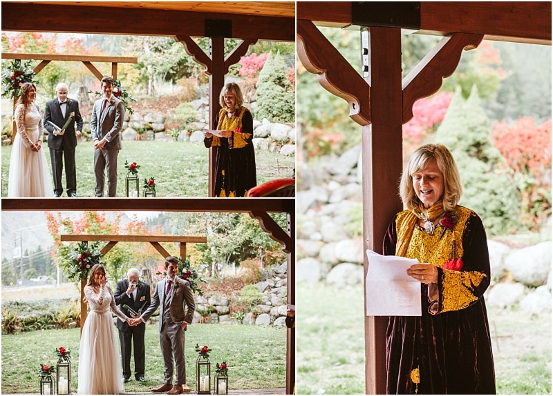Premier Snohomish & Seattle Wedding Photographer | GSquared Weddings Photography A woman in a long, ornate dress reads from a paper during an outdoor Snohomish wedding ceremony, while a couple stands with an officiant under a wooden pavilion surrounded by colorful autumn trees. 47.9129° N, 122.0982° W | Serving Snohomish, Seattle , Orlando & Beyond