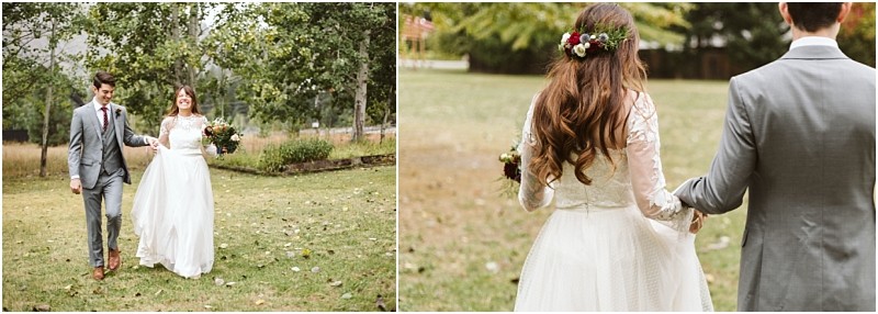 Premier Snohomish & Seattle Wedding Photographer | GSquared Weddings Photography A bride in a white dress and floral crown walks hand in hand with a groom in a gray suit across a grassy outdoor area, surrounded by trees—capturing the romance of a Snohomish Seattle wedding. 47.9129° N, 122.0982° W | Serving Snohomish, Seattle , Orlando & Beyond