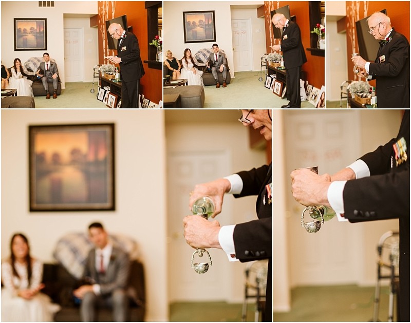 Premier Snohomish & Seattle Wedding Photographer | GSquared Weddings Photography A man in a formal suit performs a glass-pouring ritual in a living room while a seated couple—celebrating their Snohomish Seattle wedding engagement—watches. Family photos and art decorate the cozy space, enriching the intimate scene. 47.9129° N, 122.0982° W | Serving Snohomish, Seattle , Orlando & Beyond