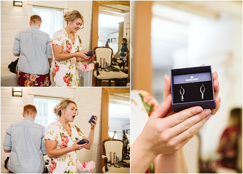 Premier Snohomish & Seattle Wedding Photographer | GSquared Weddings Photography A woman in a floral robe opens a blue Swarovski jewelry box, looking surprised and delighted—perfect for a Snohomish or Seattle wedding engagement. Close-up reveals sparkling earrings as another person stands nearby with their back turned. 47.9129° N, 122.0982° W | Serving Snohomish, Seattle , Orlando & Beyond