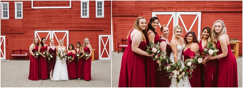 Premier Snohomish & Seattle Wedding Photographer | GSquared Weddings Photography A bride in a white gown stands with six bridesmaids in matching burgundy dresses, holding bouquets, posing in front of a large red barn with white trim and doors at a charming Snohomish wedding near Seattle. 47.9129° N, 122.0982° W | Serving Snohomish, Seattle , Orlando & Beyond