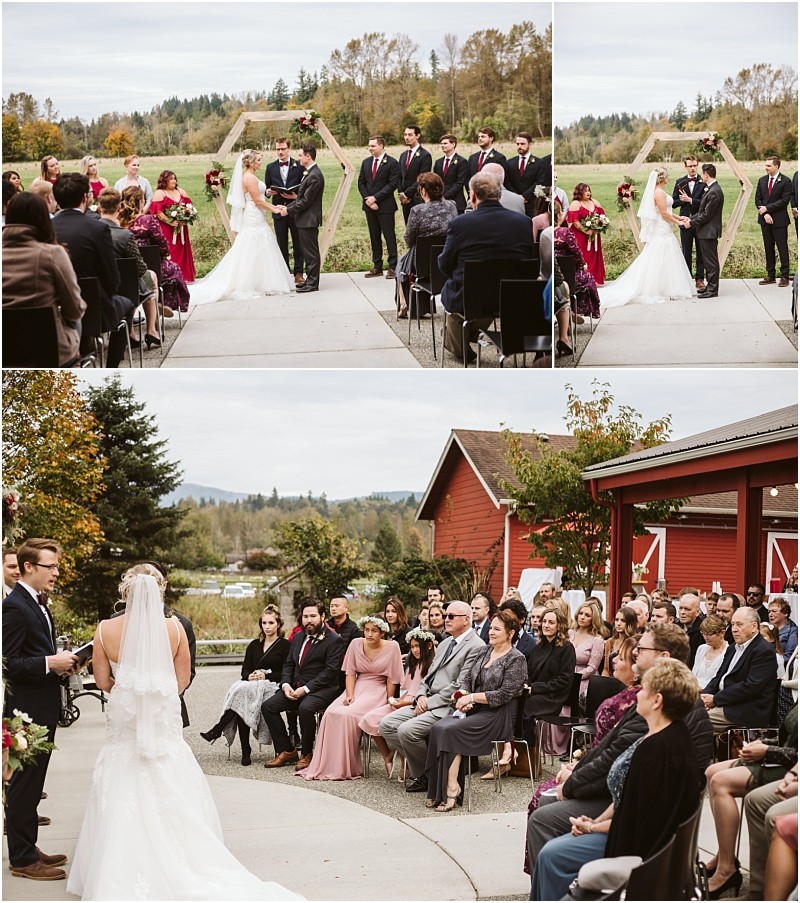 Premier Snohomish & Seattle Wedding Photographer | GSquared Weddings Photography A bride and groom stand with their wedding party outdoors, exchanging vows near a wooden arch with trees and a red barn in the background at a charming Snohomish Seattle wedding ceremony. 47.9129° N, 122.0982° W | Serving Snohomish, Seattle , Orlando & Beyond