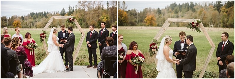 Premier Snohomish & Seattle Wedding Photographer | GSquared Weddings Photography A bride and groom stand under a wooden hexagon arch decorated with flowers during their outdoor Snohomish wedding ceremony, surrounded by their wedding party and guests, with a green field and trees in the background. 47.9129° N, 122.0982° W | Serving Snohomish, Seattle , Orlando & Beyond