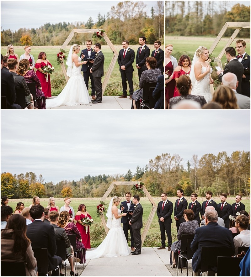Premier Snohomish & Seattle Wedding Photographer | GSquared Weddings Photography A bride and groom stand at an outdoor Snohomish wedding ceremony with their wedding party and guests. The ceremony takes place in front of a geometric wooden arch, with trees and fields in the background. 47.9129° N, 122.0982° W | Serving Snohomish, Seattle , Orlando & Beyond