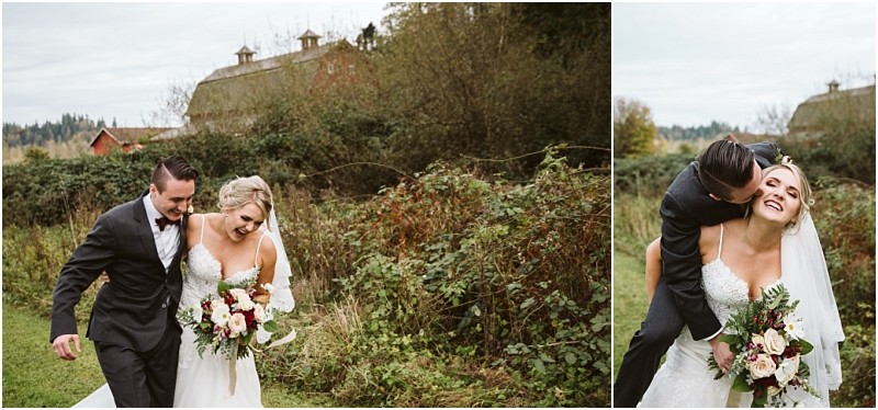 Premier Snohomish & Seattle Wedding Photographer | GSquared Weddings Photography A bride and groom joyfully walk outdoors at their Snohomish wedding, holding a bouquet of flowers. The groom hugs and kisses the bride from behind, surrounded by greenery with a rustic barn visible in the background. 47.9129° N, 122.0982° W | Serving Snohomish, Seattle , Orlando & Beyond
