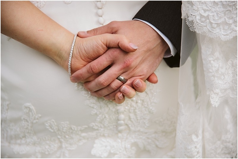 Premier Snohomish & Seattle Wedding Photographer | GSquared Weddings Photography Close-up of a Snohomish bride and groom’s hands gently clasped together, showing wedding rings and lace details on the bride’s dress and veil during their Seattle wedding engagement. 47.9129° N, 122.0982° W | Serving Snohomish, Seattle , Orlando & Beyond
