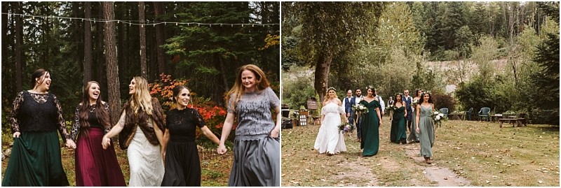 Premier Snohomish & Seattle Wedding Photographer | GSquared Weddings Photography A group of women in long skirts and dresses walk outdoors in a wooded area near Snohomish, smiling and laughing together. The background features trees, greenery, and string lights, creating a rustic setting perfect for a Seattle wedding engagement. 47.9129° N, 122.0982° W | Serving Snohomish, Seattle , Orlando & Beyond