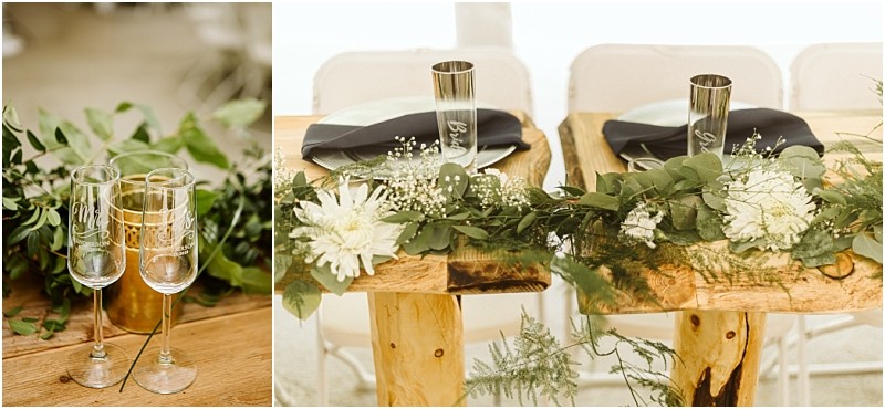 Premier Snohomish & Seattle Wedding Photographer | GSquared Weddings Photography Two wooden tables with rustic decor, greenery, white flowers, and black napkins set the scene for a Snohomish Seattle wedding. Two engraved champagne flutes rest on one table, with simple chairs arranged behind for an intimate celebration. 47.9129° N, 122.0982° W | Serving Snohomish, Seattle , Orlando & Beyond