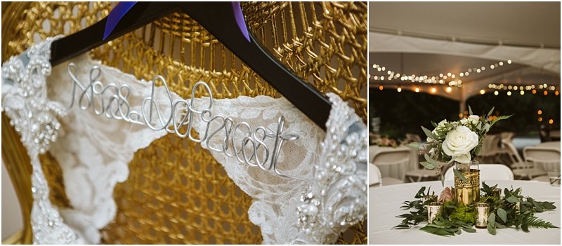 Premier Snohomish & Seattle Wedding Photographer | GSquared Weddings Photography A lace wedding dress hangs on a black hanger with Mrs. DeForest in wire; beside it, a tented Snohomish reception table is decorated with white flowers, greenery, and gold accents under string lights. 47.9129° N, 122.0982° W | Serving Snohomish, Seattle , Orlando & Beyond