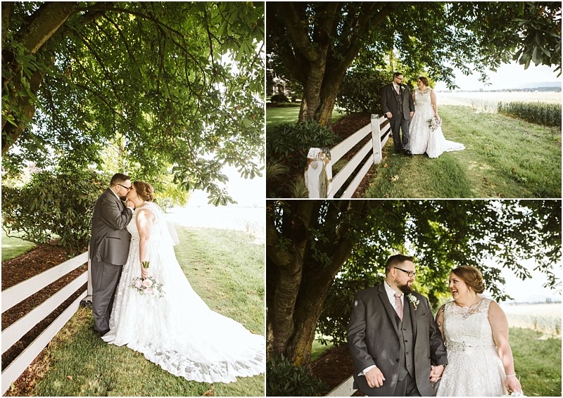 Premier Snohomish & Seattle Wedding Photographer | GSquared Weddings Photography A bride and groom stand together outdoors by a white fence and large green tree, sharing loving looks and holding hands on their Snohomish wedding day. The setting is bright and lush with greenery. 47.9129° N, 122.0982° W | Serving Snohomish, Seattle , Orlando & Beyond