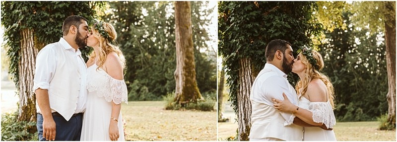 Premier Snohomish & Seattle Wedding Photographer | GSquared Weddings Photography A couple in wedding attire kisses outdoors in front of a tree covered in green ivy, surrounded by greenery and warm sunlight. Perfect for a romantic Snohomish or Seattle wedding engagement, the bride wears an off-shoulder white dress and flower crown. 47.9129° N, 122.0982° W | Serving Snohomish, Seattle , Orlando & Beyond