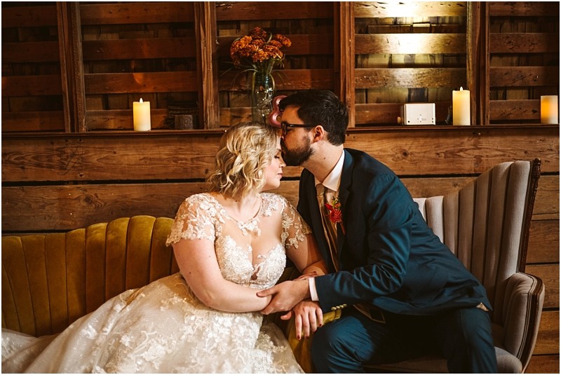 barn at holly farm classic couple on a vintage couch groom kissing brides forehead snohomish wedding photographer seattle