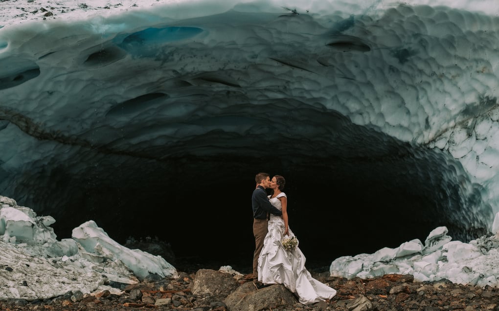 Elopement at Big Four Ice Caves in Granite Falls Washington with blue and white ice and a white wedding gown