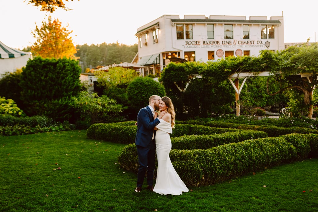 A bride and groom embrace and smile in a manicured garden at sunset with a historic white building labeled Roche Harbor Lime Cement Co in the backgroundone of the most charming Seattle wedding venues surrounded by lush greenery Snohomish Wedding Photography A bride and groom embrace and smile in a manicured garden at sunset with a historic white building labeled Roche Harbor Lime & Cement Co in the backgroundone of the most charming Seattle wedding venues surrounded by lush greenery Snohomish Wedding Photography