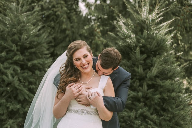 Wedding couple at Trinity Tree Farm Barn among the Christmas trees