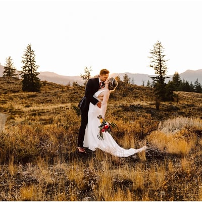 Sun Mountain Lodge Fall Wedding Bride and Groom in the sunset with the dried grass and mountains and trees