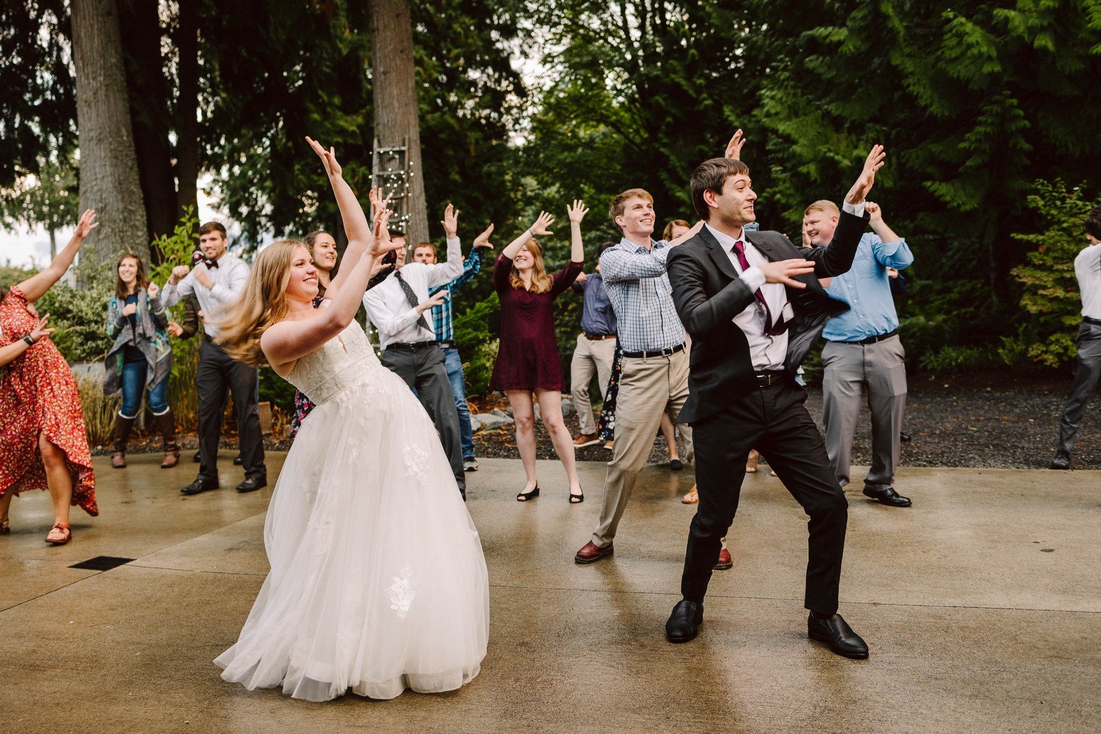 wedding couple and wedding guests dancing to michael jacksons song thriller as a group bride and groom at the front at the snohomish venue the lookout lodge intentional wedding planning and events in seattle and snohomish