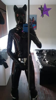 Rubber pup locked inside a carrara with a tail plug in his ass