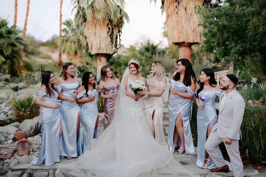 Bride surrounded by bridesmaids in powder blue satin dresses