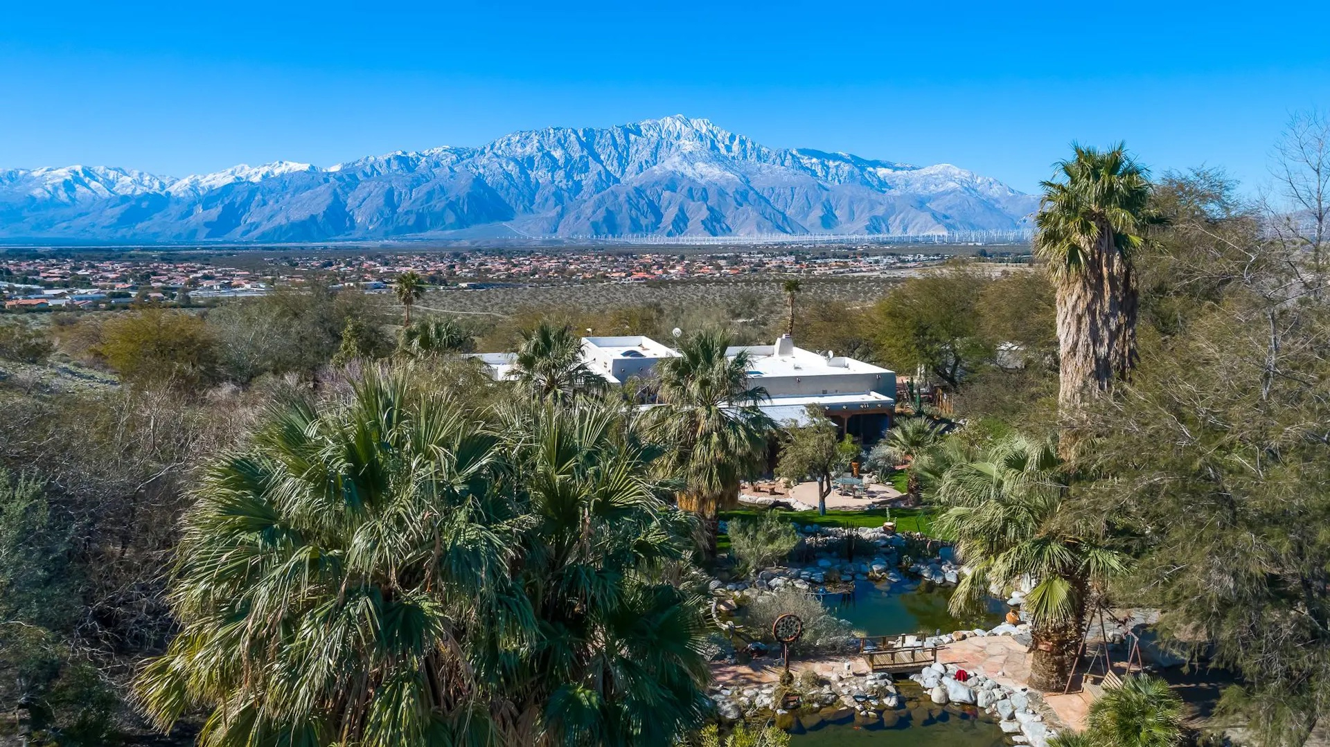 Aerial view of the full Bubbling Wells Oasis estate — 107 acres of desert sanctuary