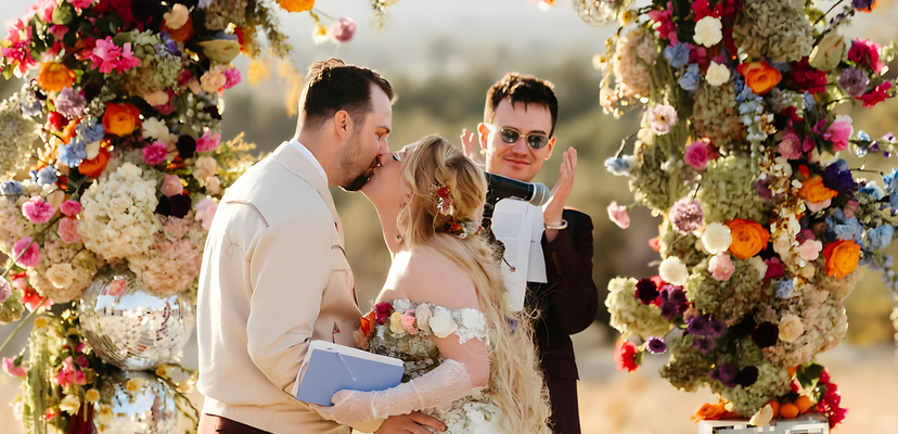 Desert wedding ceremony with floral arch at Bubbling Wells Oasis