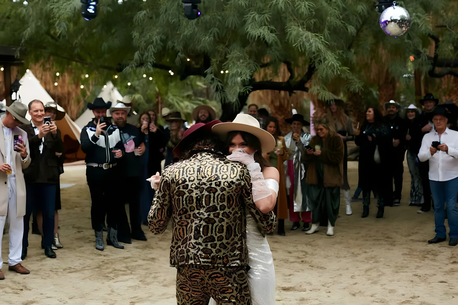 First dance under string lights with cowboy hats at Bubbling Wells Oasis western venue