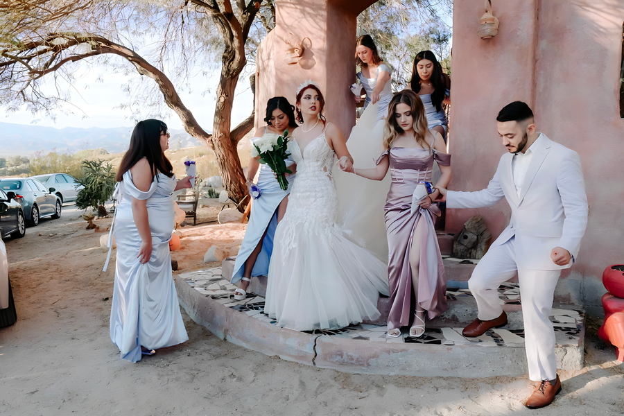 Bride and bridesmaids preparing at the pink adobe pavilion overlooking desert views