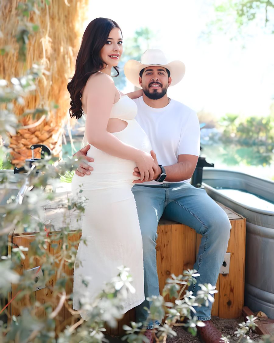 Couple posing by the hot springs tub at Bubbling Wells Oasis desert ranch