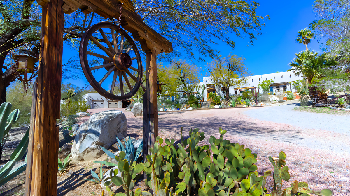 Property overview with main residence and desert landscape
