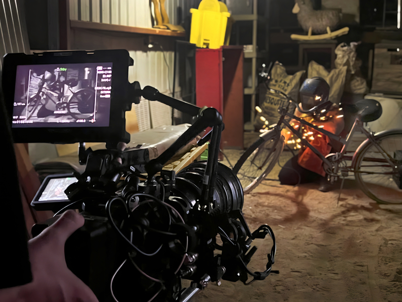 Camera filming welding scene in rustic interior