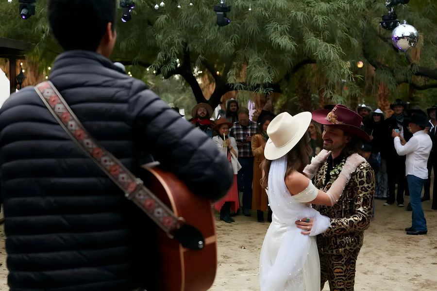 Live guitarist serenading couple during first dance at Bubbling Wells Oasis outdoor reception