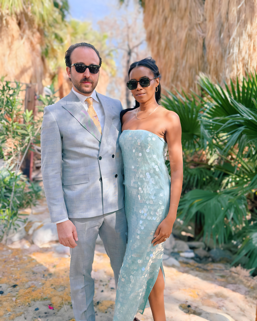 Elegant couple posing between the iconic palm corridor at Bubbling Wells Oasis