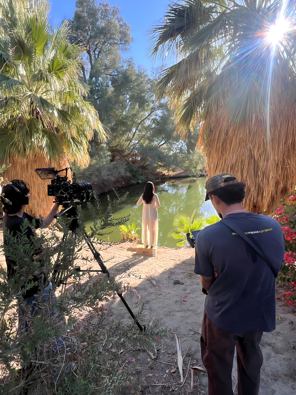 Film production crew shooting by natural hot springs