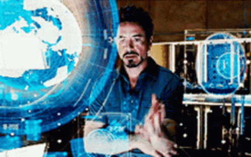 a man is standing in front of a computer screen