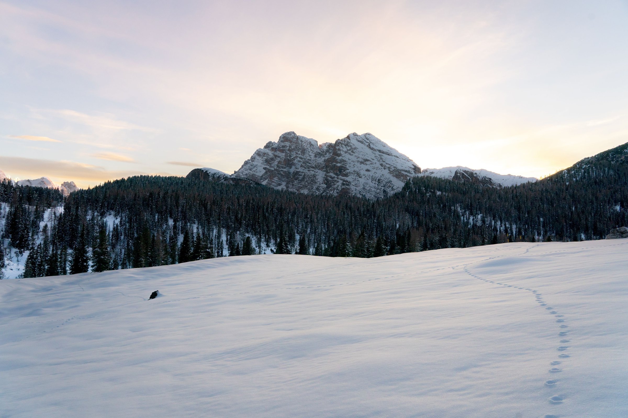 Pegunungan Dolomites bersalju dengan tebing batu menjulang.