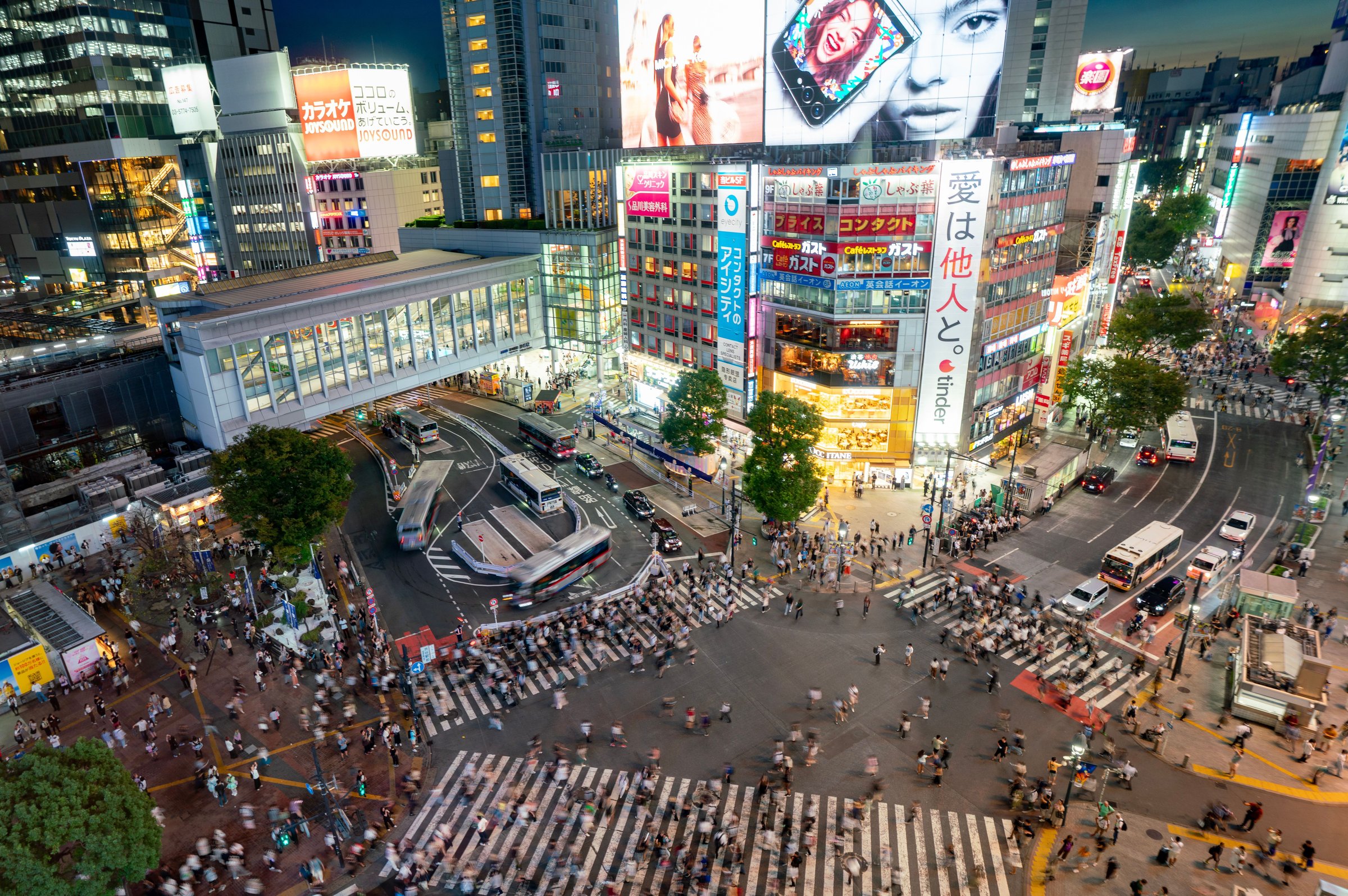Persimpangan Shibuya Scramble Crossing Tokyo dipenuhi lampu neon dan pejalan kaki malam hari