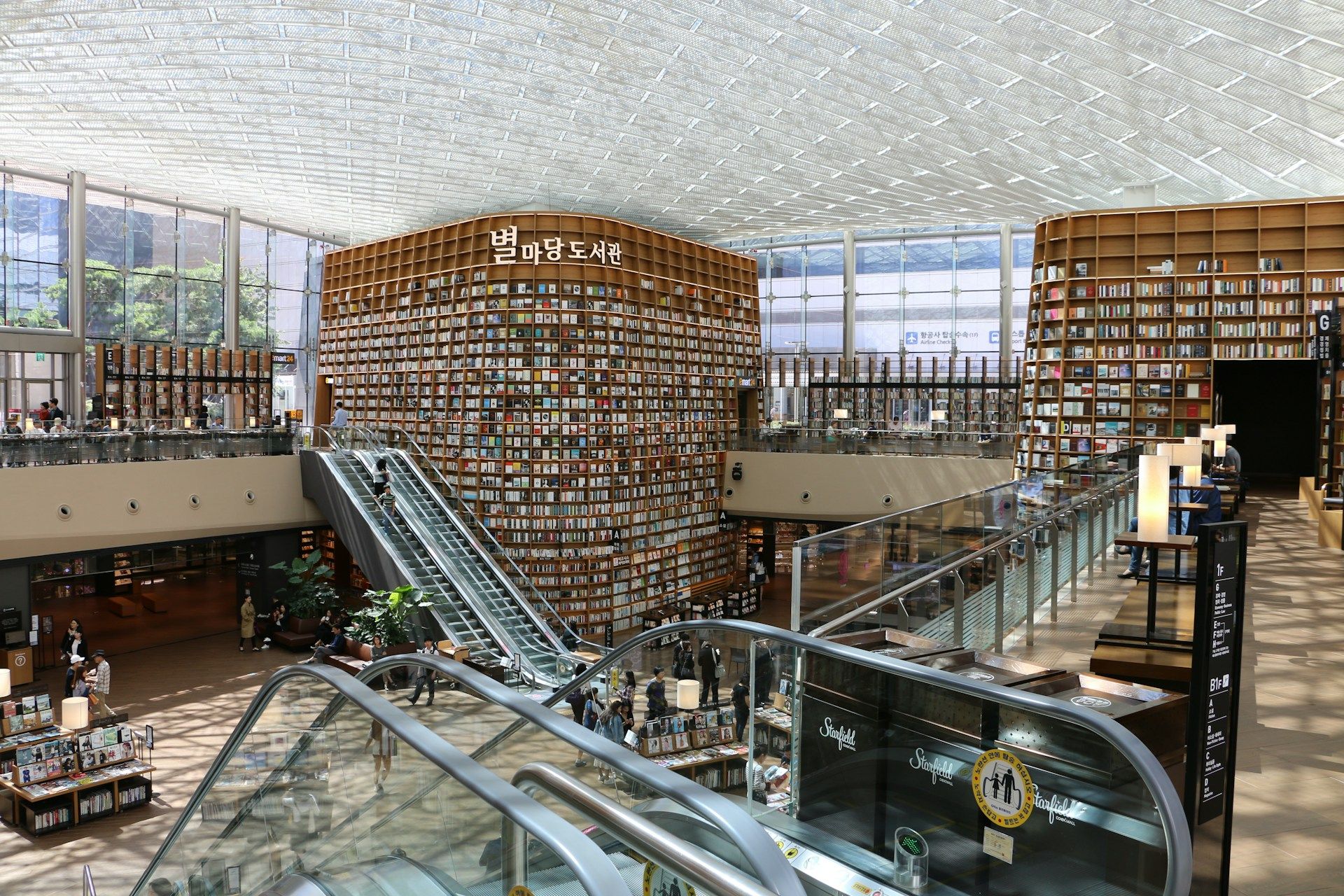 Bookwall raksasa Starfield Library di COEX Mall Gangnam Seoul dengan signage Korea dan langit-langit kubah anyaman
