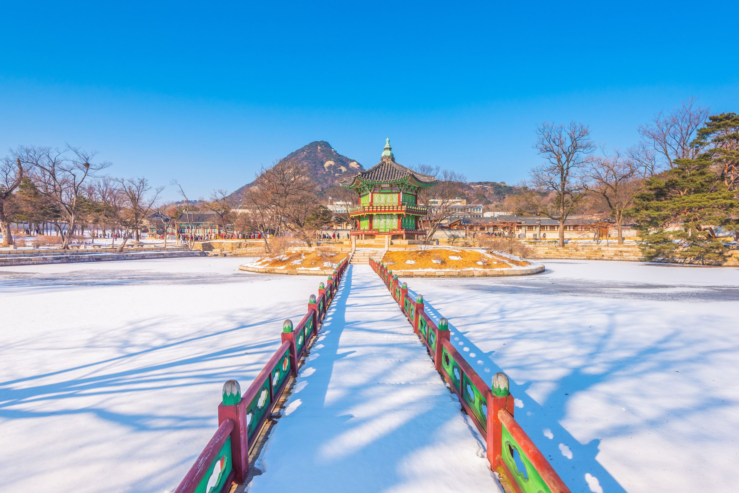 Jembatan merah hijau dan paviliun Hyangwonjeong di Istana Gyeongbokgung yang tertutup salju