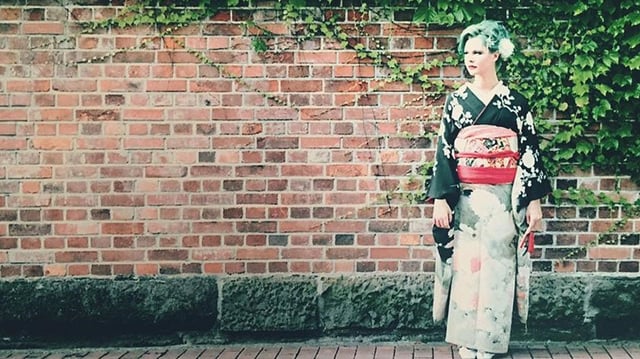 Alexa in a kimono by a wall