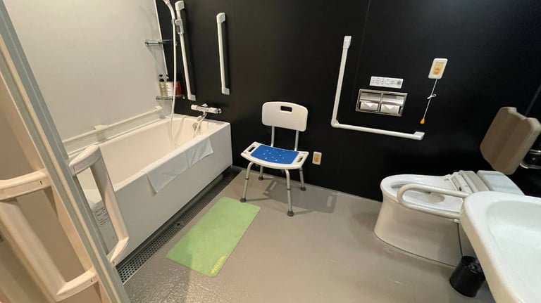 Unit bath with bath tub, shower chair, and toilet