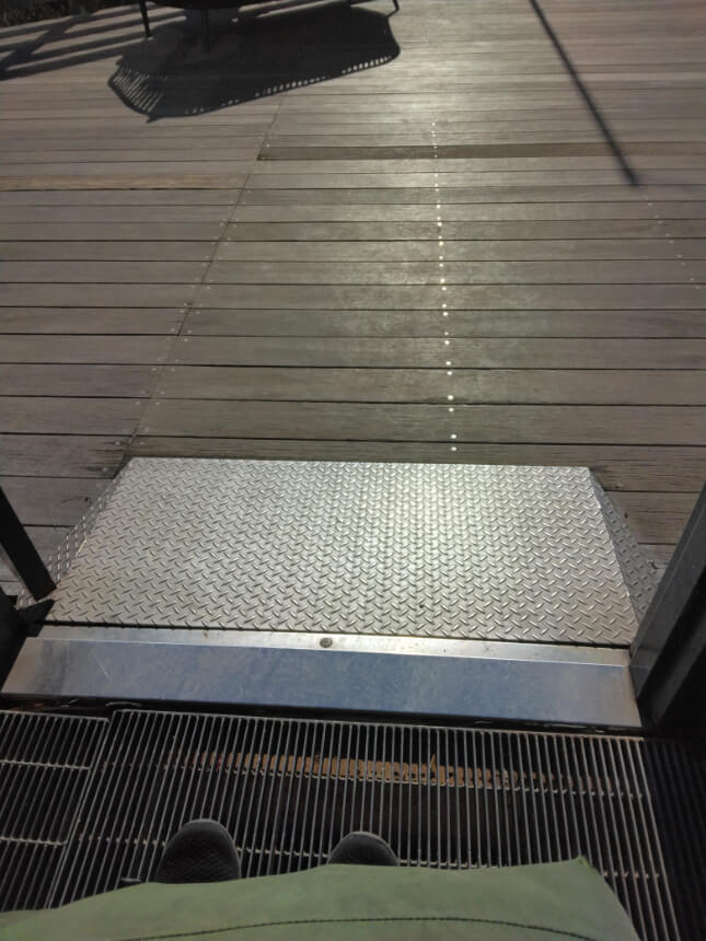 Gentle metal slope leading from the Glasshouse to the wooden deck outside. Gentle metal slope leading from the Glasshouse to the wooden deck outside.