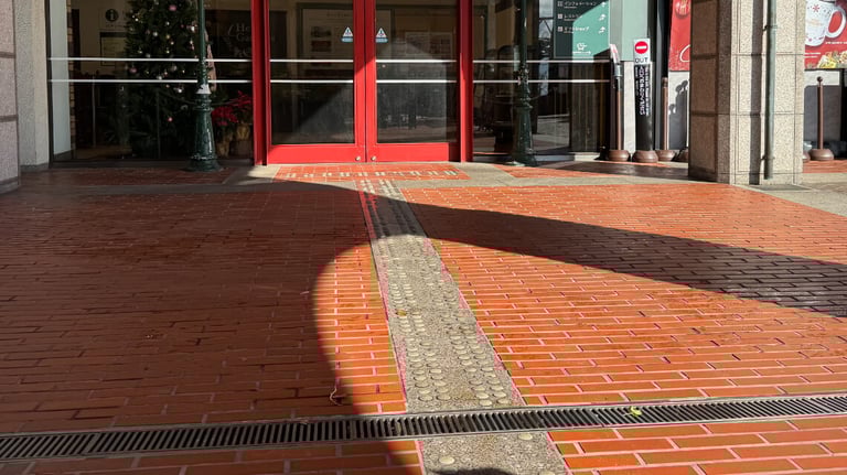 Tactile pavement on a red brick walkway leading to the guest center at the top of the Kobe Nunobiki Herb Gardens ropeway. Tactile pavement on a red brick walkway leading to the guest center at the top of the Kobe Nunobiki Herb Gardens ropeway.