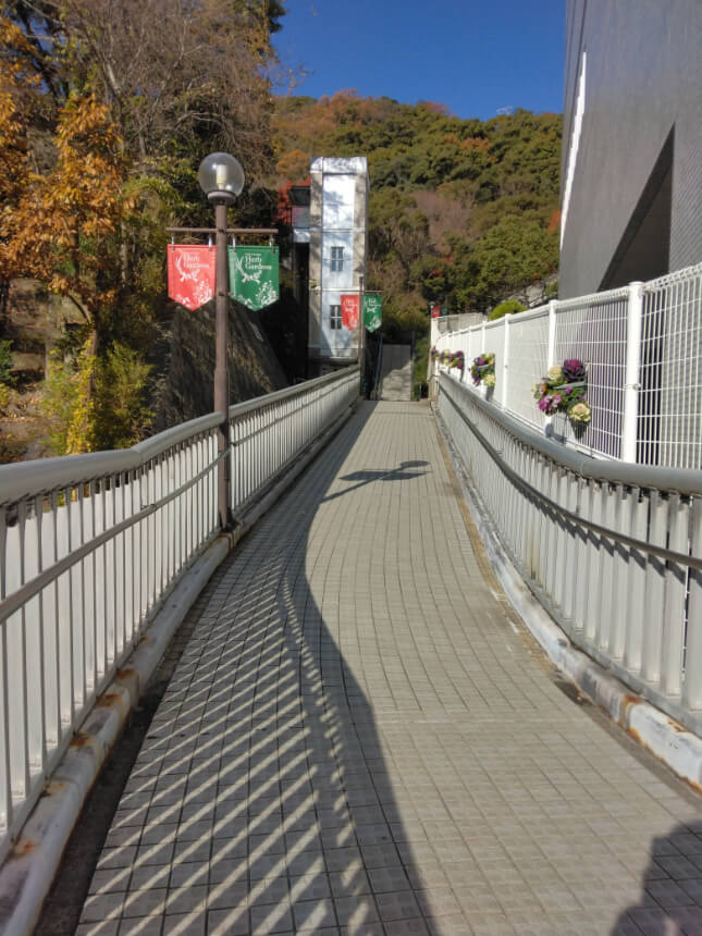 Tiled pathway leading to the ropeway with an elevator in the distance.